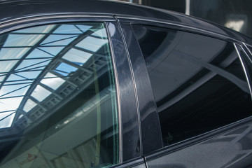 tinted black car Windows that reflect the glass ceiling
