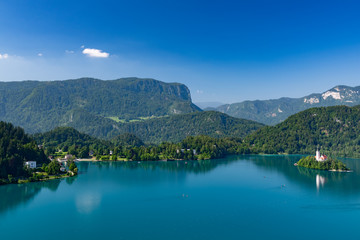 Beautiful landscape of Lake Bled with Pilgrimage Church of the Assumption of Maria with tourist kayaking in the lake.