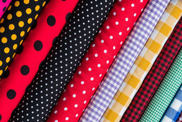 Colorful fabric scarves in stack as background