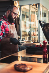Chef grilling steak in a restaurant