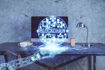 Double exposure of blockchain and crypto economy theme hologram and table with computer background....