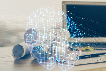Double exposure of table with computer and brain hologram. Data innovation concept.