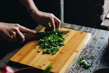 Woman hands chopping parsley