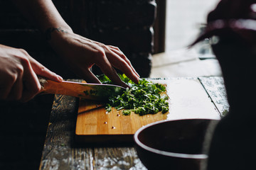 Woman hands chopping parsley