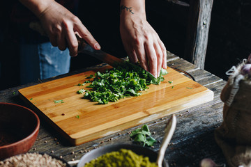 Woman hands chopping parsley