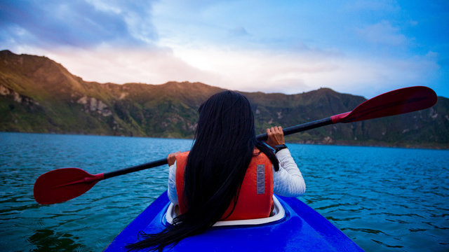 tourist doing canopi in lagoon with mountain in background
