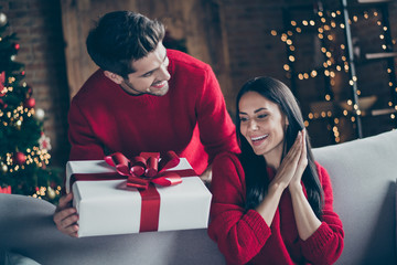 Portrait of two brunet haired romantic couple give new year christmas x-mas present to his lady sit...