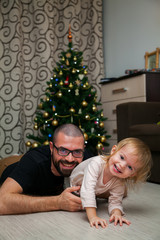 man fooling around with his little daughter