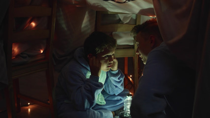 Boys sit, talk and laugh together.