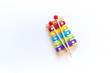 Toys for games with children. Musical instrument made of wood. Bright rainbow.
