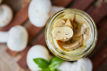 Marinated pickled champignon mushrooms (Agaricus bisporus) in jar