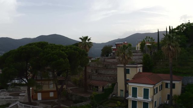 Drone flying between trees, revealing&nbsp;city&nbsp;of&nbsp;La&nbsp;Spezia,&nbsp;Italy