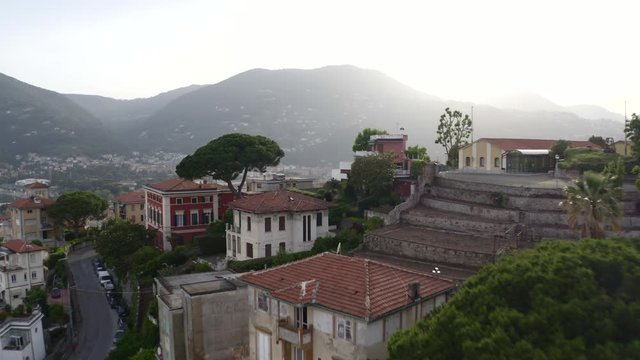 Drone flying over houses and between trees in La Spezia, Italy