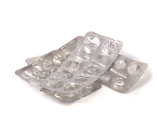 Pile of Empty Blister Pill Packs on White Background. Medicine and money saving concept.