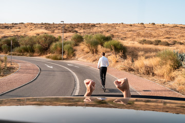 furious driver with a man traveling on electric scooter