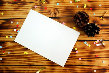 on a wooden table lies paper for congratulations strewn with confetti