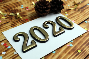 on the table is paper with golden color in numbers 2020