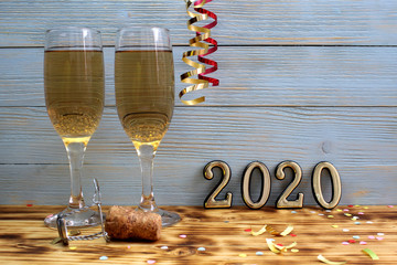 two glasses of champagne are poured to the New Year's tabl