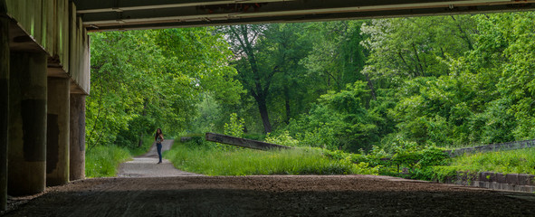 woman standing on bridge over lock