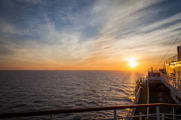 Sun about to set, seen from the upper deck of a cruise ship
