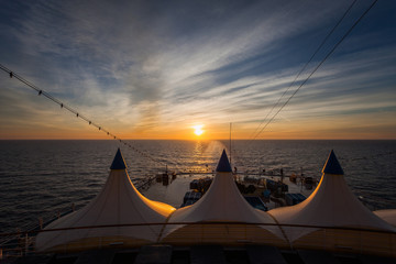 Sun about to set, seen from the stern of a cruise ship