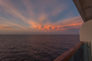 Moon rising over the sea from the deck of a cruise ship