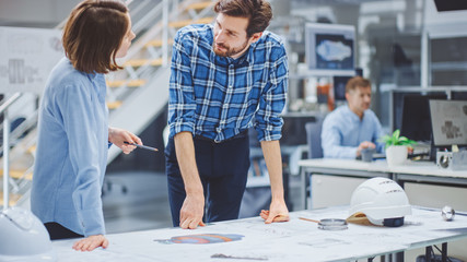 In the Industrial Engineering Facility: Young Female Designer Works with Chief Industrial Engineer,...
