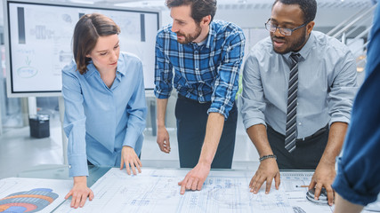 In the Industrial Engineering Facility: Diverse Group of Engineers and Technicians on a Meeting...