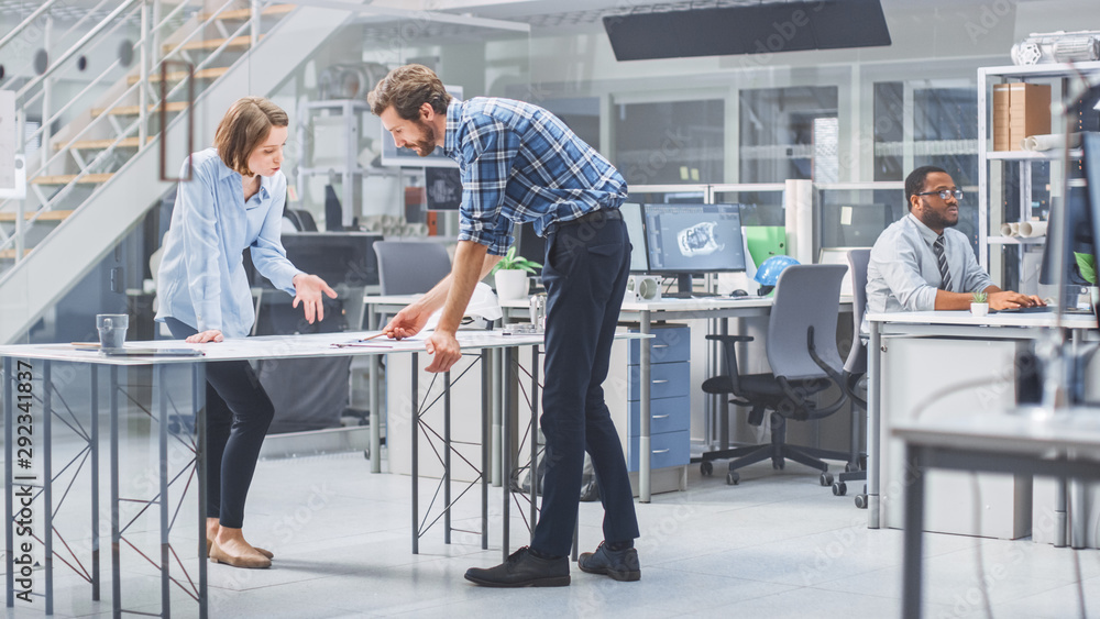 Poster In the Industrial Engineering Facility: Female Architect Prints Drafts of Industrial Engine Prototype and Brings Them to Chief Engineer, Start Discussion and Analysis Using Conference Table. 