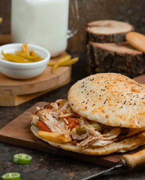 Chichen doner kebab with fries, cucumber prinkles, tomato in pita bread