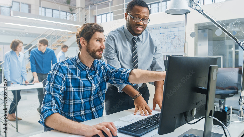 Leinwandbilder in the industrial engineering facility: portrait of the handsome male engineer working on desktop co