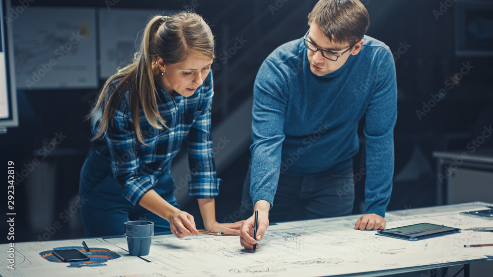 Poster in the dark industrial design engineering facility male and female engineers talk and work on a blue