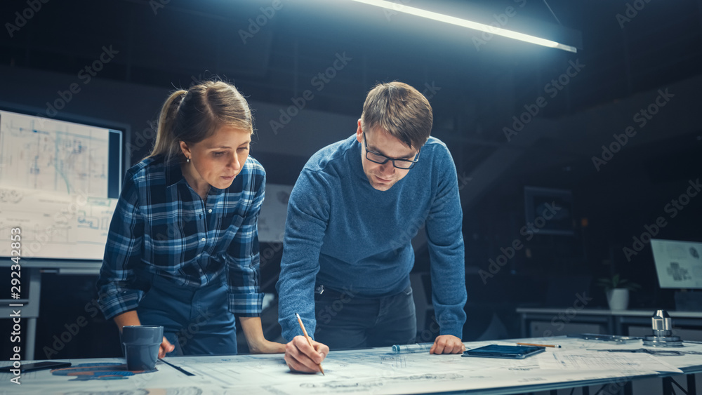 Aufkleber in the dark industrial design engineering facility male and female engineers talk and work on a blue