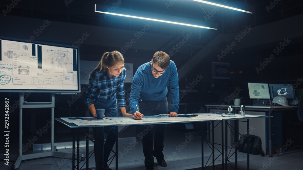 Aufkleber in the dark industrial design engineering facility male and female engineers talk and work on a blue