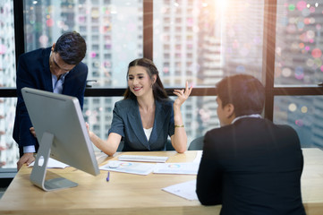 A group of business people working together in the office and joint planning.