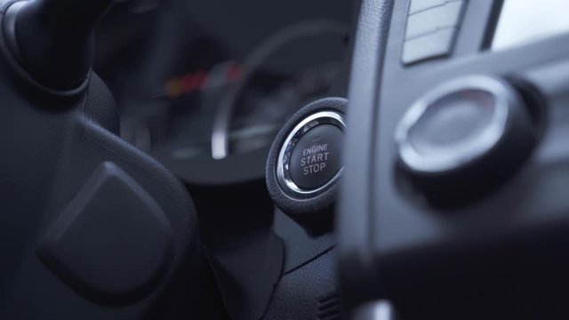 man presses engine start button speedometer illuminates