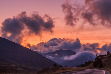 Reddish sunset with clouds on the horizon in the mountain