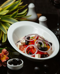 Greek salad in a white bowl