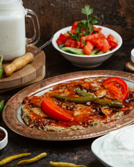 Grilled bbq beefsteak on top of the mashed aubergine with chile sauce