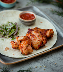 Grilled chicken kebab in the wrap with salad