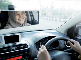 Fototapeta premium Smiling Muslim Lady Driving a Car