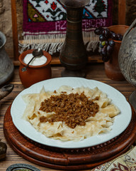 Khingal noodle sheets with fried minced meat and yogurt