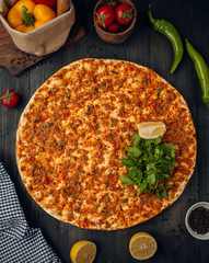 Lahmajun turkish pizza with minced meat, tomato, pepper, served with parslay, lemon