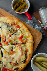 Mix pizza with meat, tomato, bell peppers, cheese on top