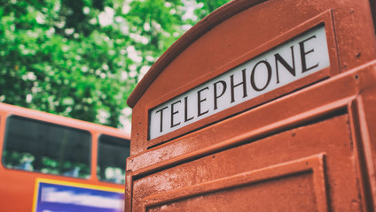Telephone red booth with double decker bus in London