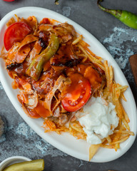 Roasted chicken pieces served with crispy shoestring potatoes, yoghurt and grilled vegetables