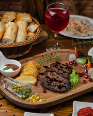 Stake slices with fried potato and salad