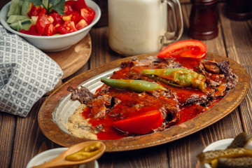 Thinly cut lamb with tomato sauce, on top of grilled aubergine