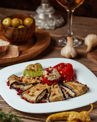 Three sisters dolma stuffed vegetables with minced meat in white plate