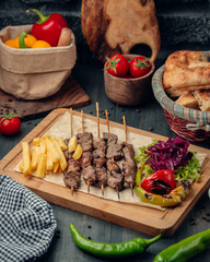 Tikka kebab served with french fries and green salad